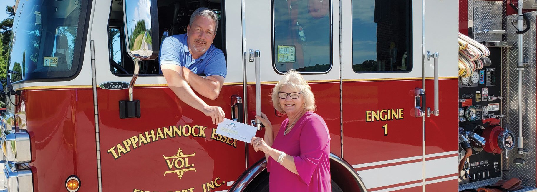 Lady presenting check to Fire Chief