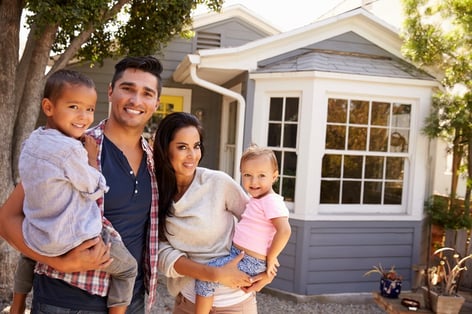 Family standing together outside home