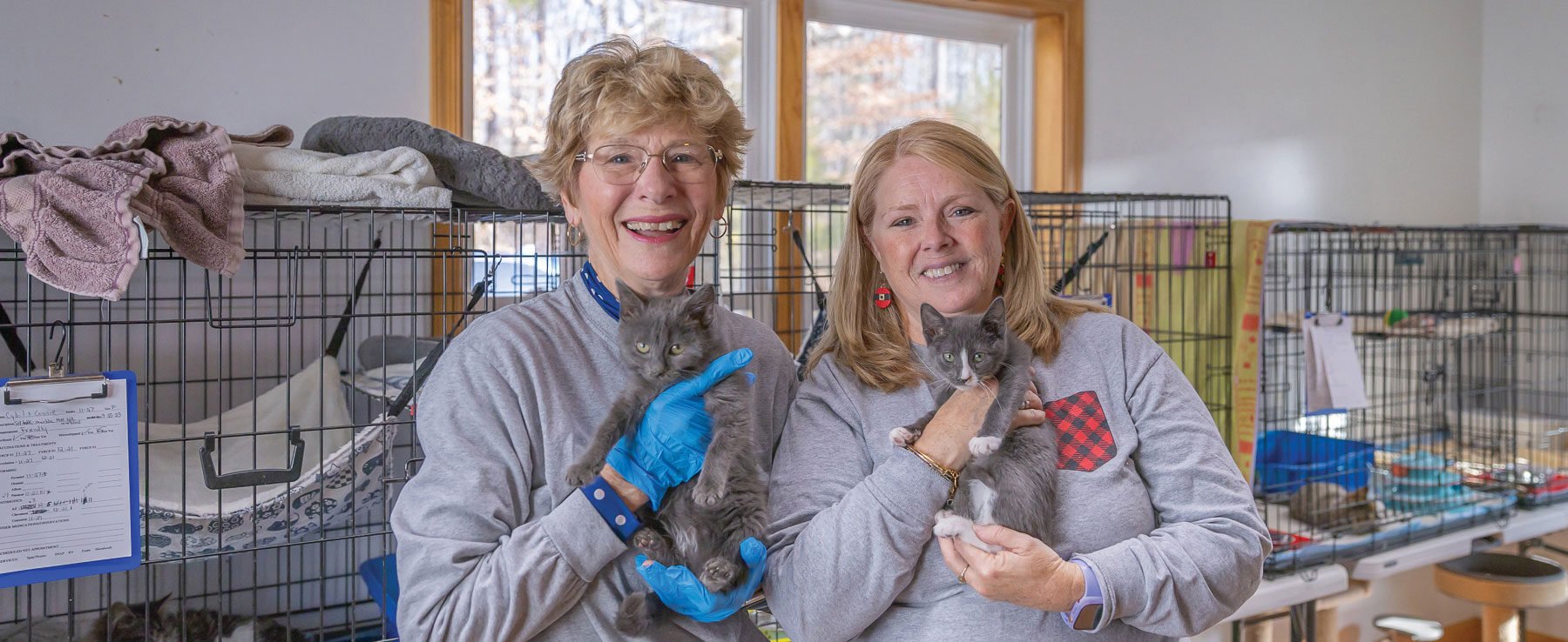 Two women holding kittens