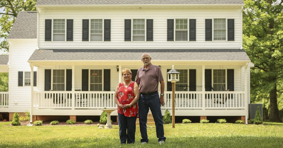 The Harpers in front of their home