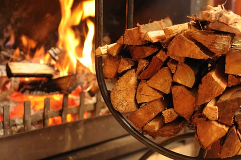 Home Fireplace with fire and wood stacked