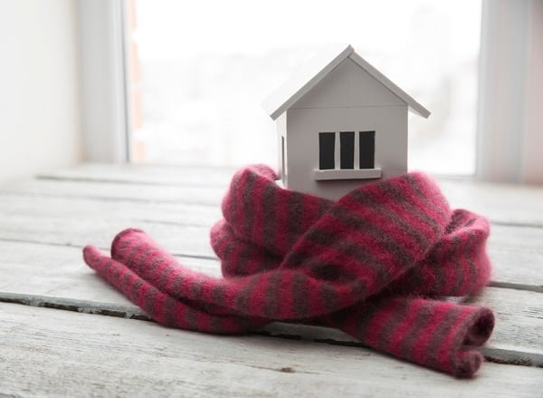 Small metal house wrapped in scarf