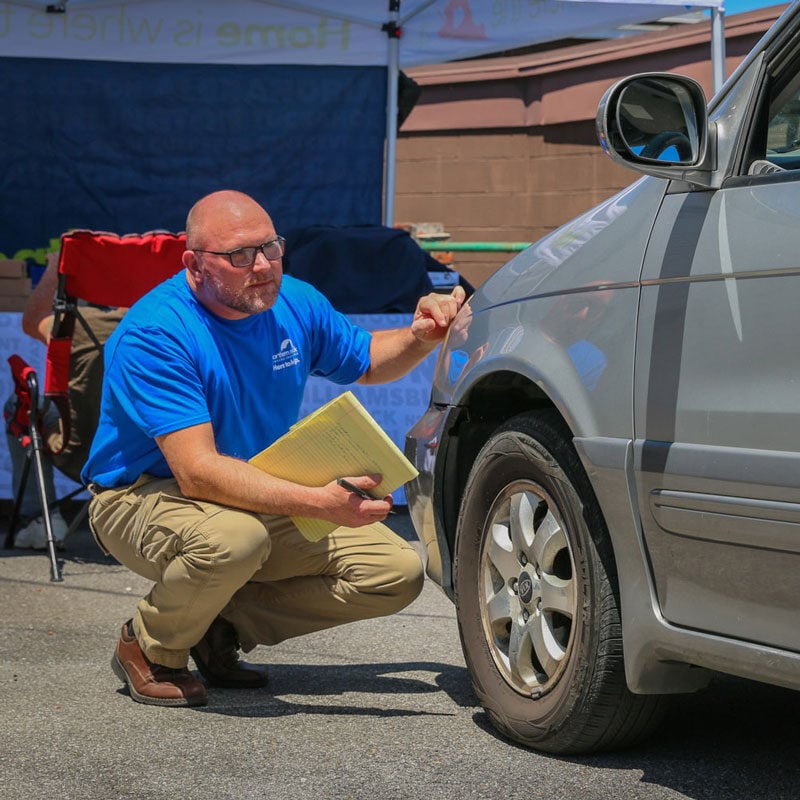 Mickey inspecting a car