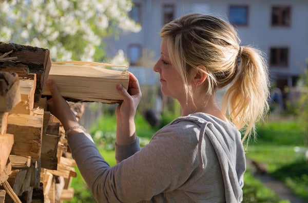 Woman stacking firewood