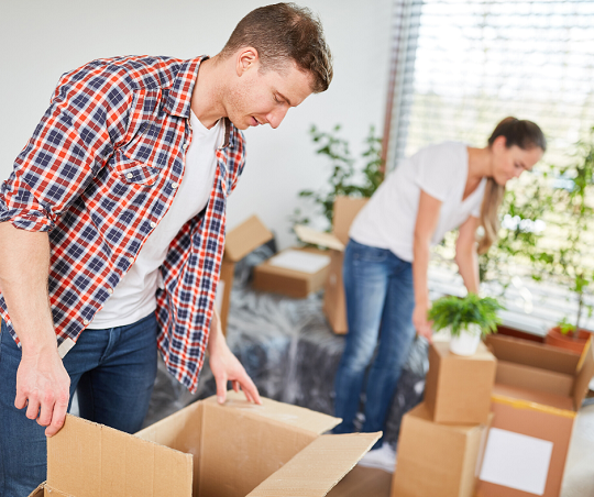 guy and girl unpacking boxes