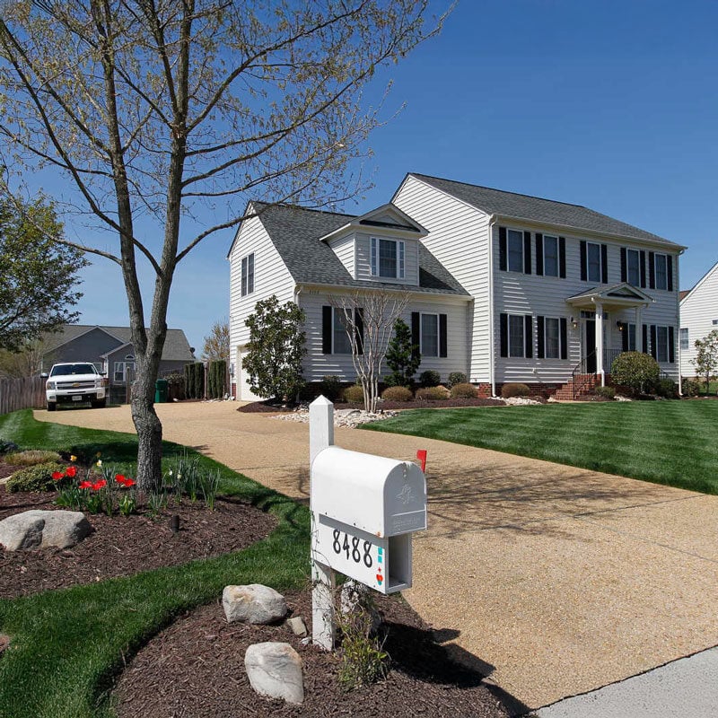 middle class home with car in the driveway