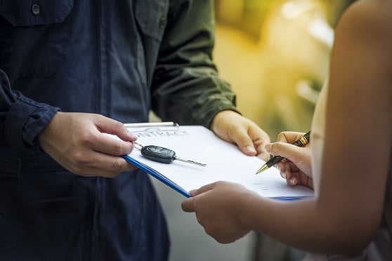 rental car man giving paper contract to woman-1