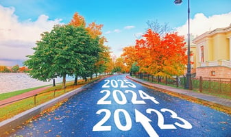 Fall tree-lined street showing years on pavement