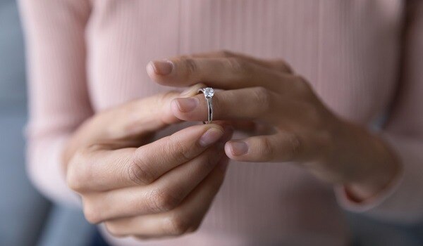 womans hand with diamond ring