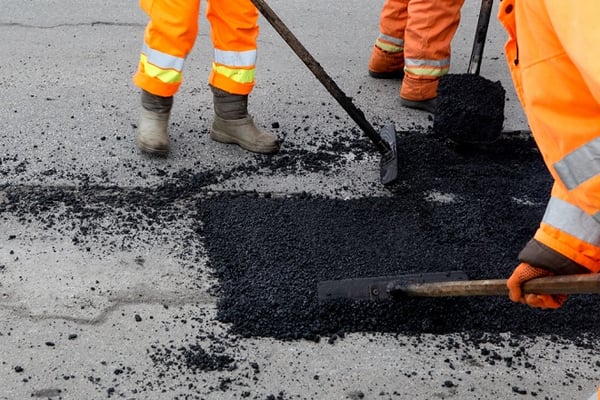 workers repairing pothole